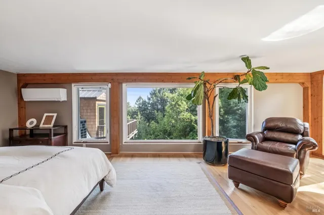 a bedroom with furniture and large windows