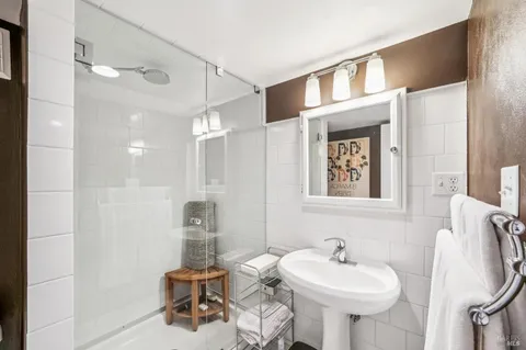 a bathroom with a sink a mirror and a shower