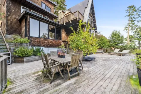 a view of a patio with table and chairs and potted plants