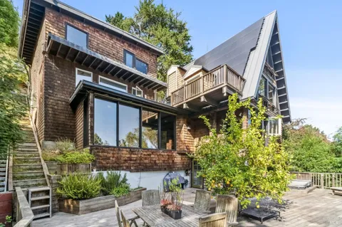 a front view of a house with plants