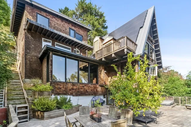 a front view of a house with plants