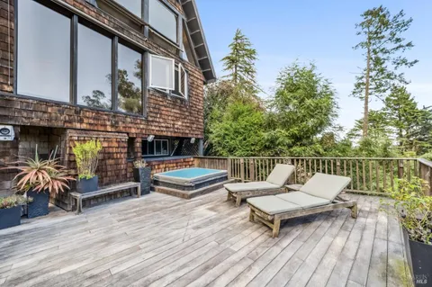 a view of a chairs and table on the deck with wooden floor
