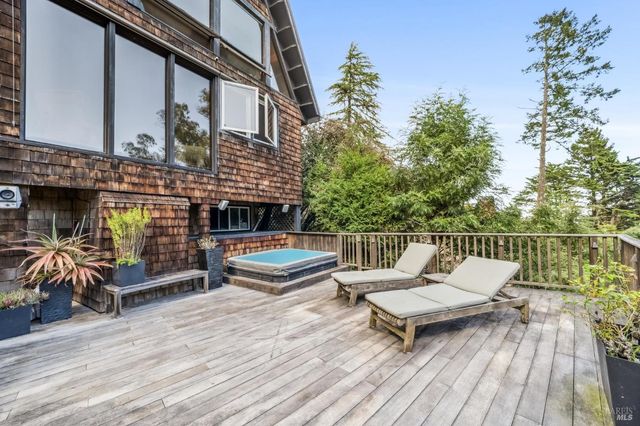 a view of a chairs and table on the deck with wooden floor