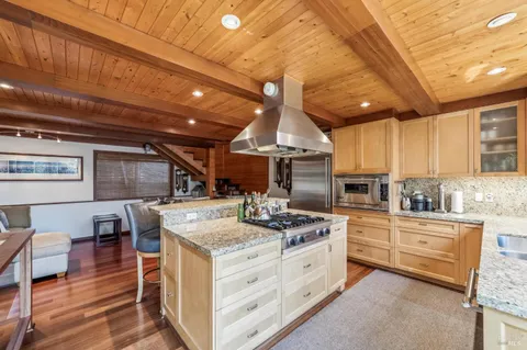 a kitchen with a stove a sink and a refrigerator