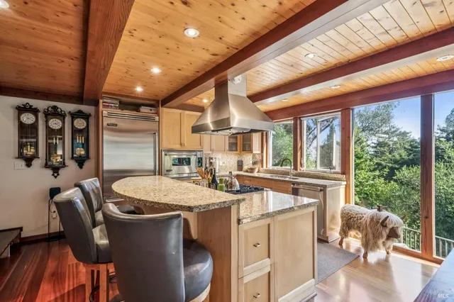 a room with furniture a large window and wooden floors