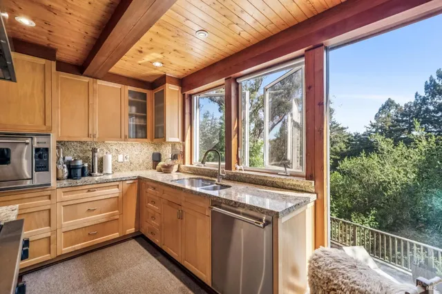 a kitchen that has a sink and a large window