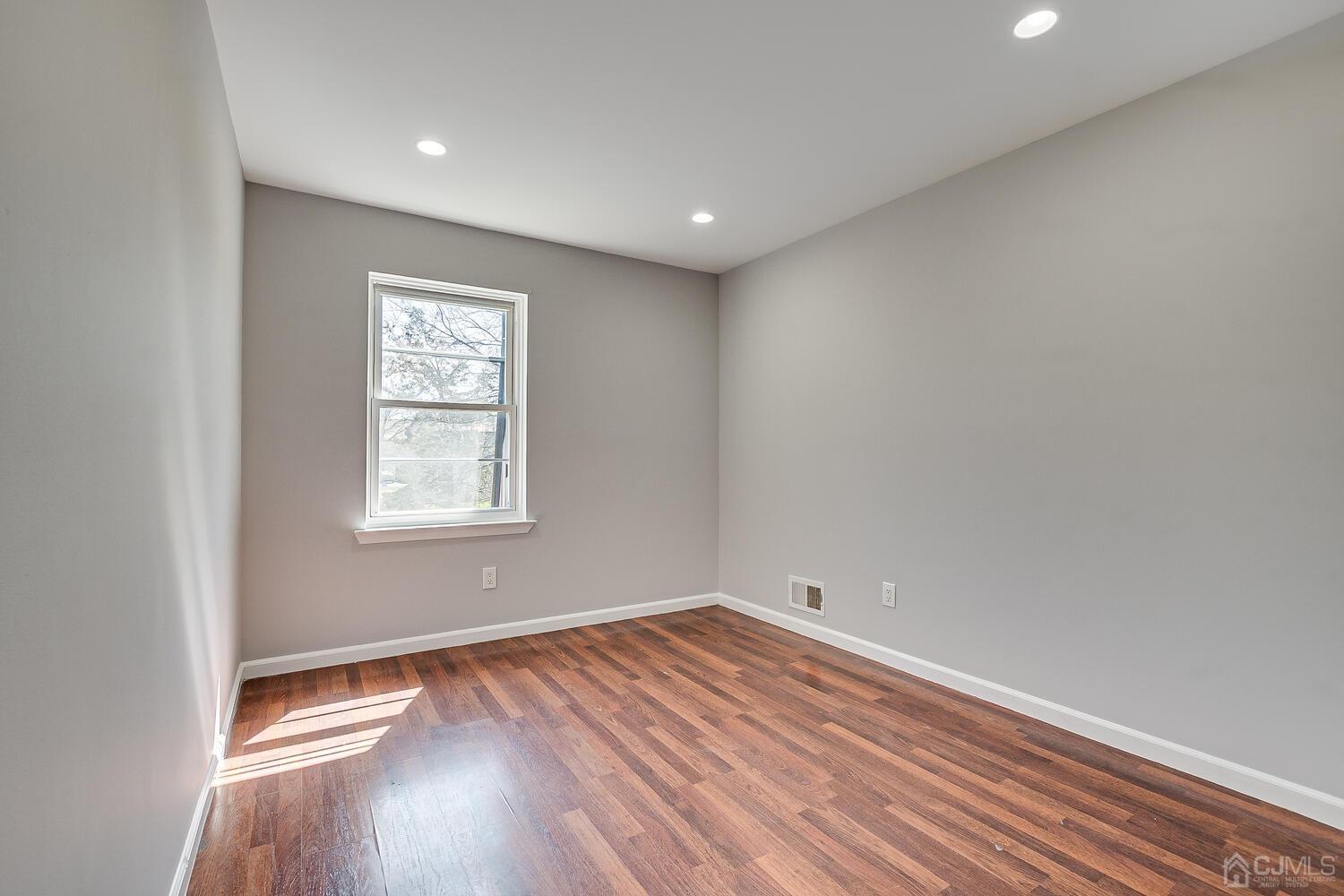 6308 Hana Road Edison, NJ 08817 - Photo 26 of 35 a view of room with wooden floor and window