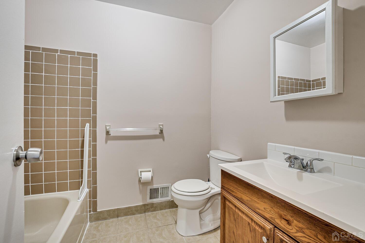 6308 Hana Road Edison, NJ 08817 - Photo 28 of 35 a bathroom with a sink a toilet and shower