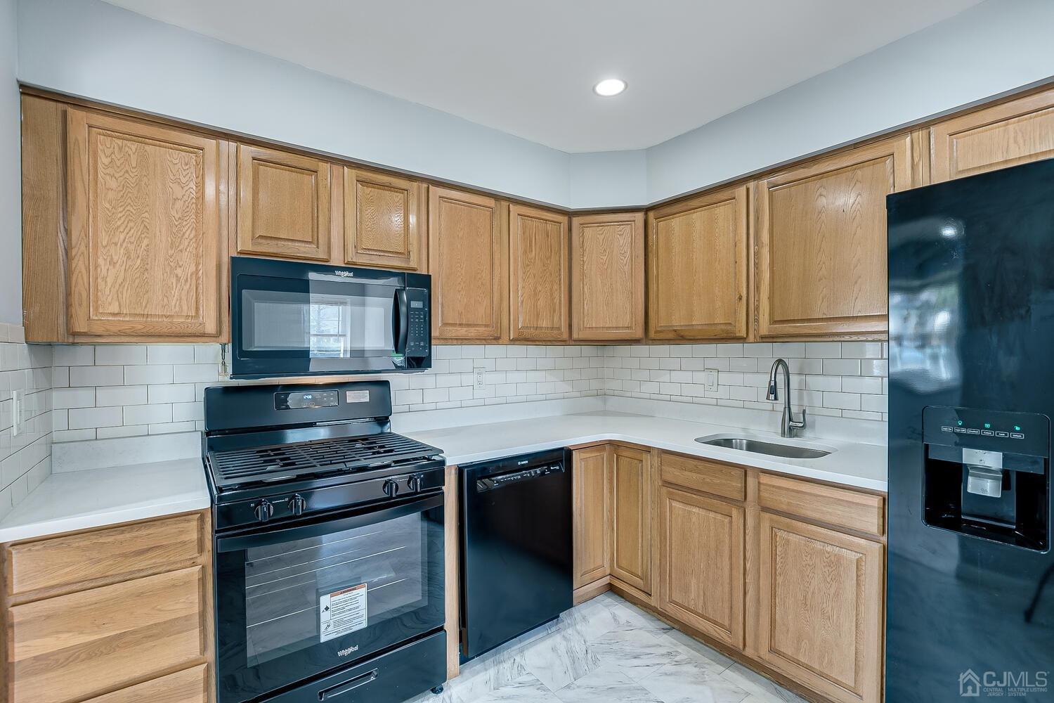 6308 Hana Road Edison, NJ 08817 - Photo 8 of 35 a kitchen with a sink stove and microwave