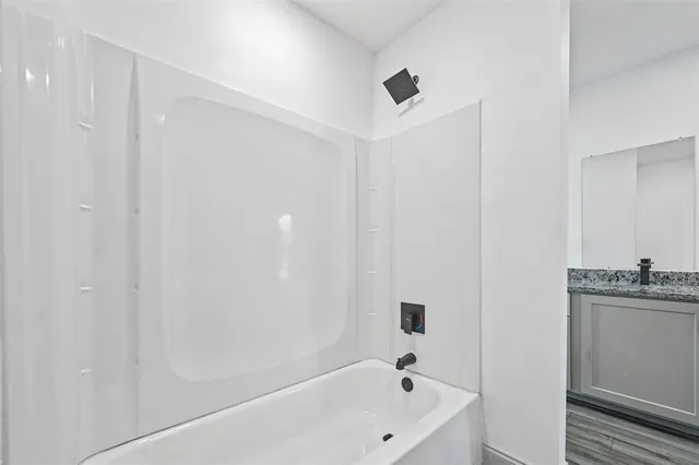 a white bath tub sitting next to a white sink