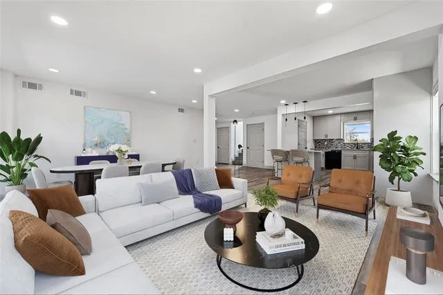 a living room with furniture potted plant and a fireplace