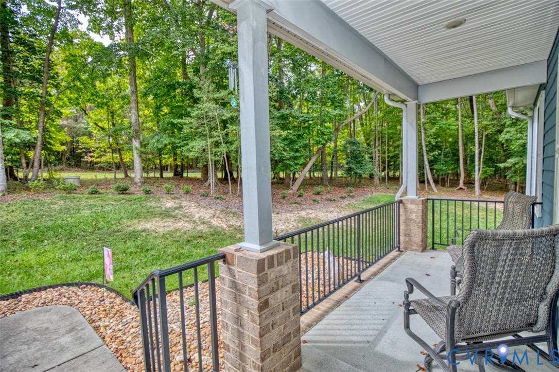 7075 Menzels Road Toano, VA 23168 - Photo 4 of 50 Covered porch with concrete flooring, brick-clad c