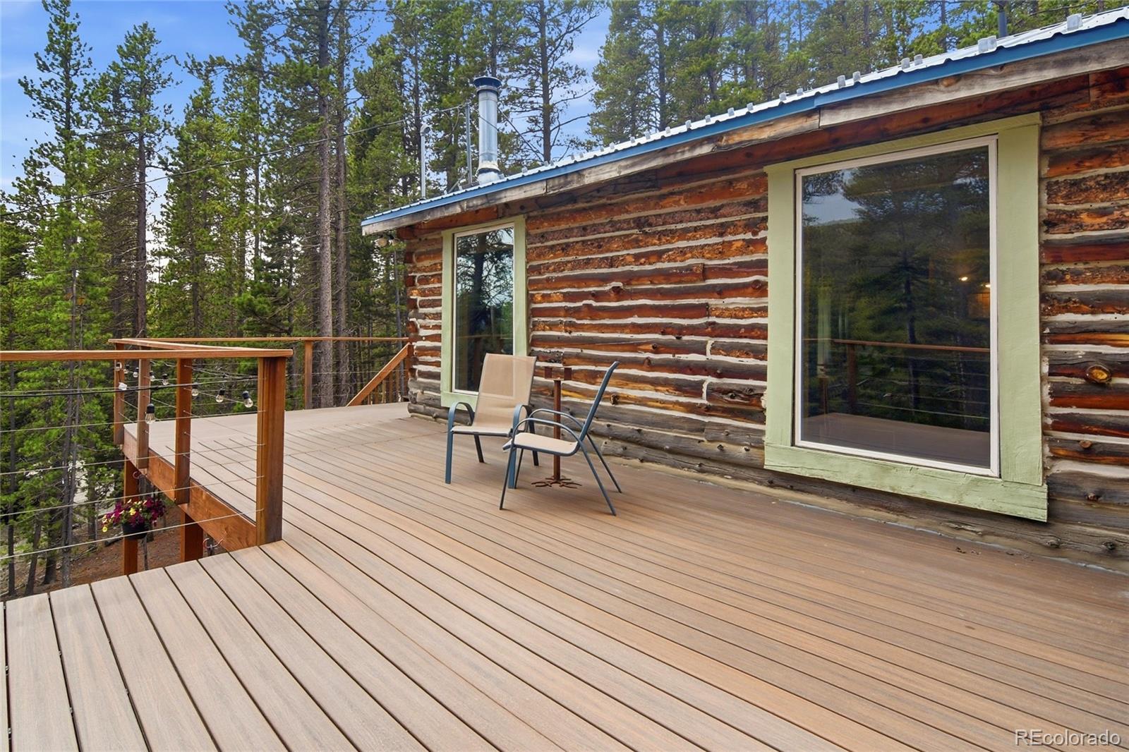 185 Alice Road Idaho Springs, CO 80452 - Photo 16 of 43 a balcony with wooden floor table and chairs