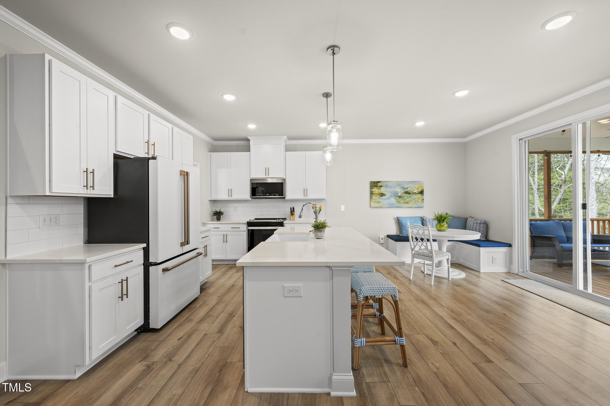 111 Kim Bark Path Garner, NC 27529 - Photo 12 of 52 a kitchen with stainless steel appliances kitchen island granite countertop a refrigerator a stove top oven a sink dishwasher and white cabinets with wooden floor