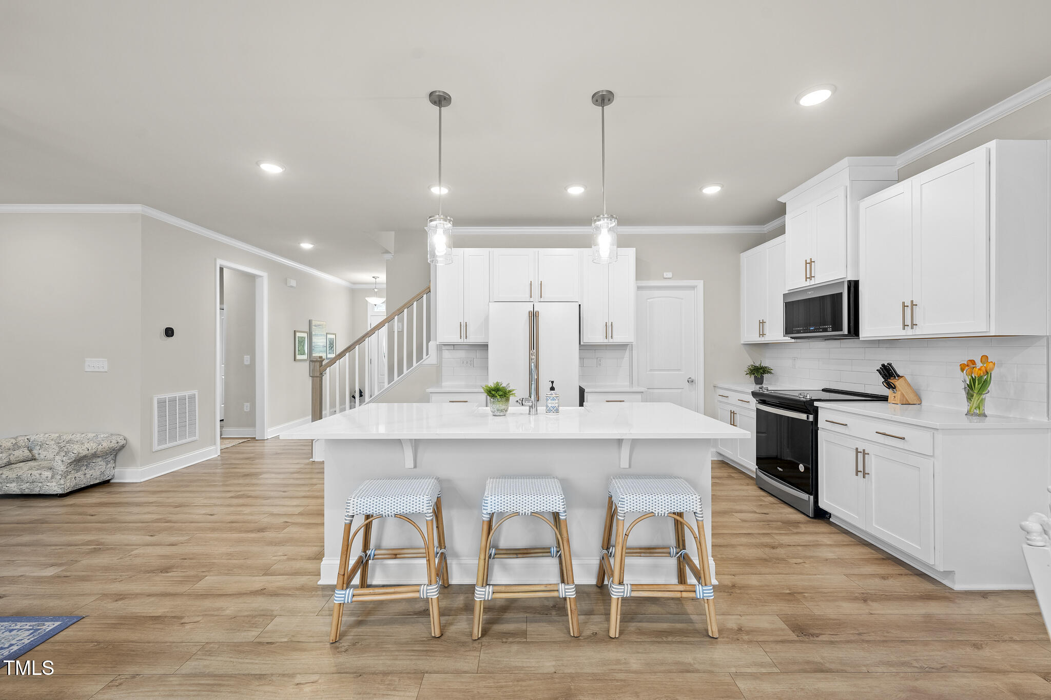 111 Kim Bark Path Garner, NC 27529 - Photo 20 of 52 a large kitchen with cabinets wooden floor and stainless steel appliances