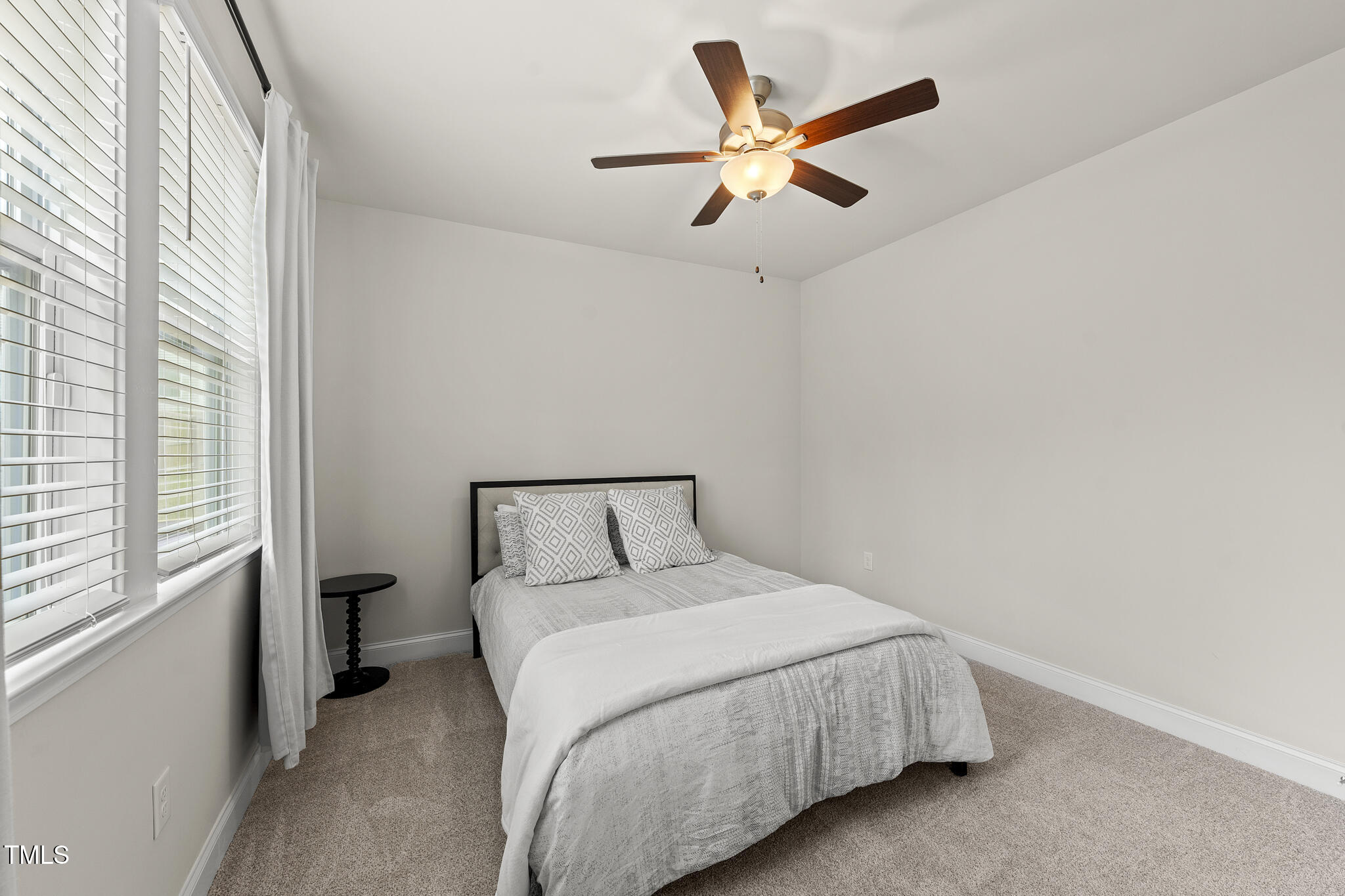111 Kim Bark Path Garner, NC 27529 - Photo 24 of 52 a bedroom with a large bed and a large window