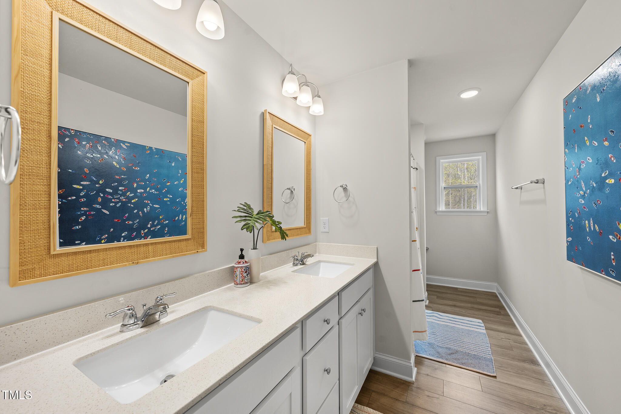 111 Kim Bark Path Garner, NC 27529 - Photo 33 of 52 a bathroom with a sink a mirror and a vanity