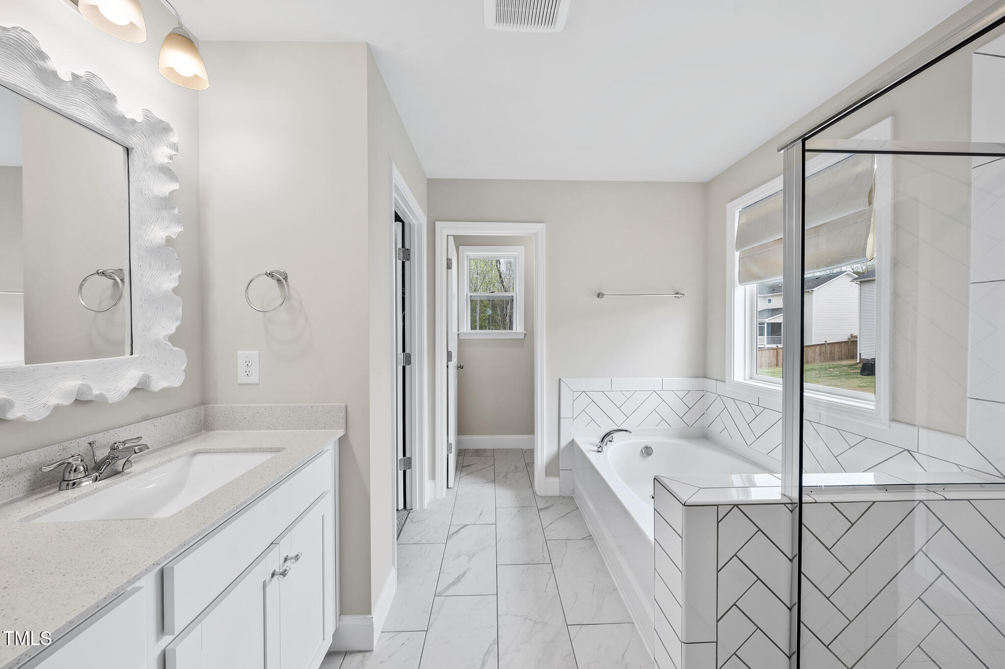 111 Kim Bark Path Garner, NC 27529 - Photo 43 of 52 a spacious bathroom with a tub sink and mirror