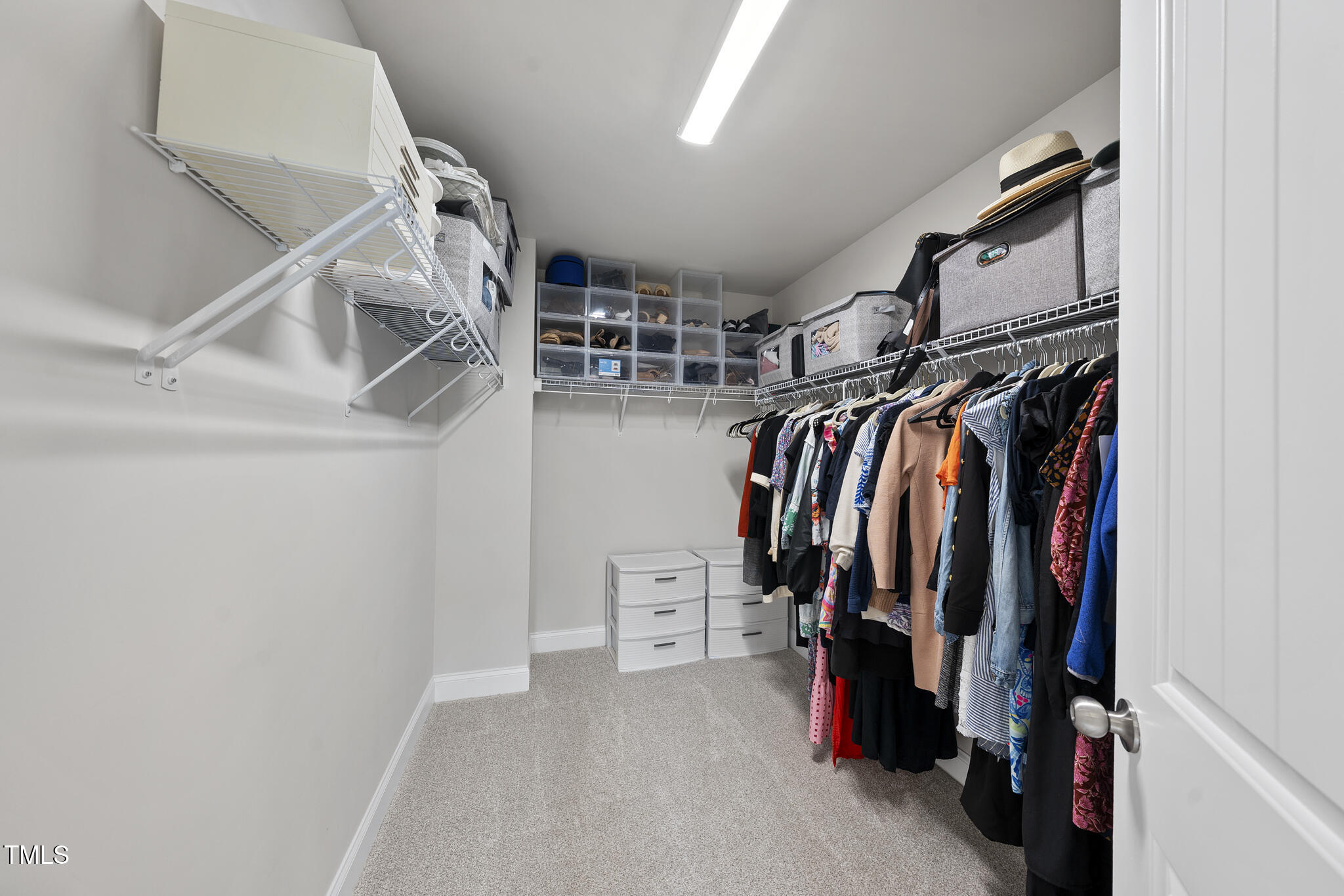 111 Kim Bark Path Garner, NC 27529 - Photo 45 of 52 a view of walk in closet with clothes and shoes