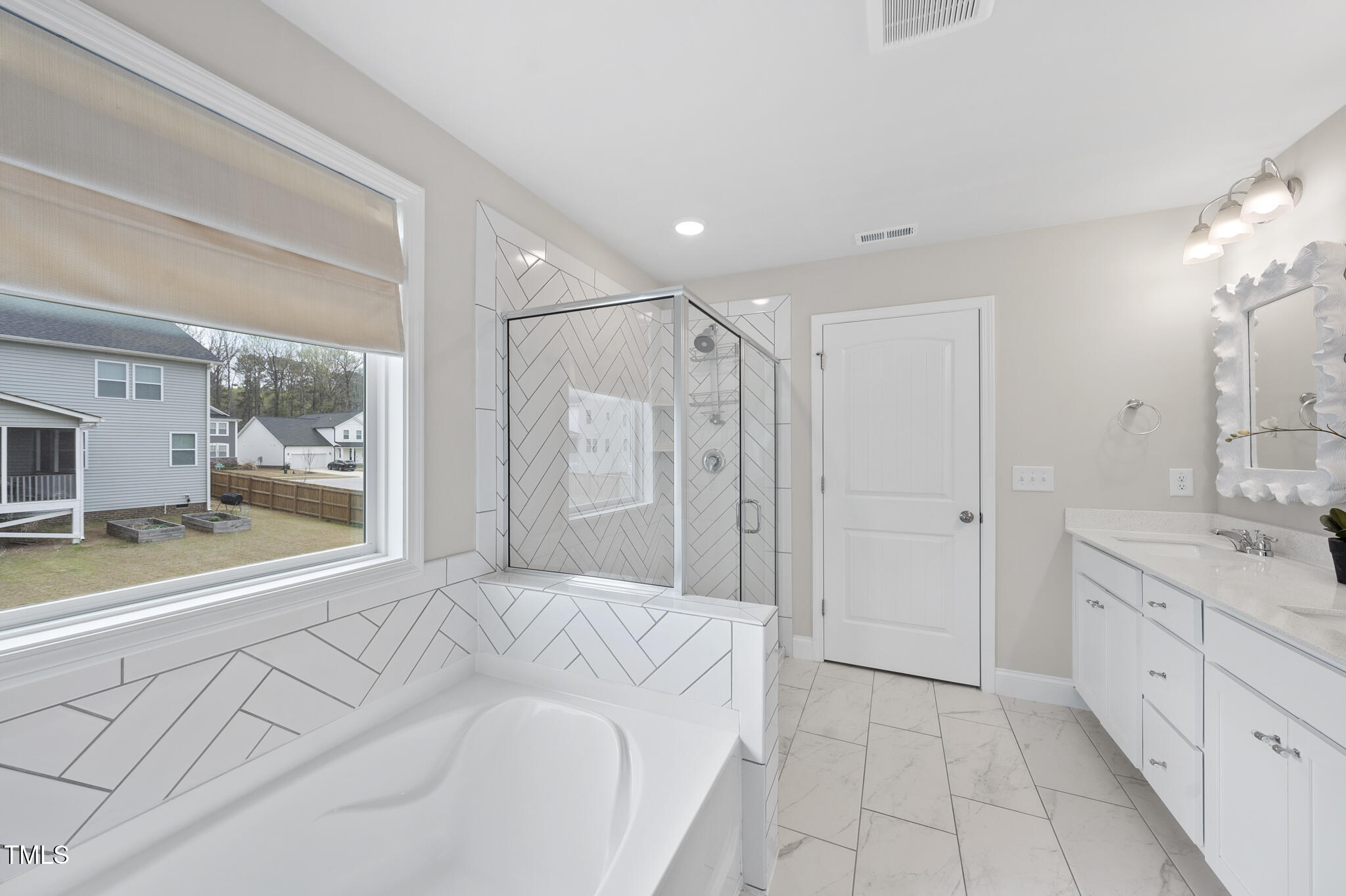 111 Kim Bark Path Garner, NC 27529 - Photo 46 of 52 a spacious bedroom with a large bed and a sink