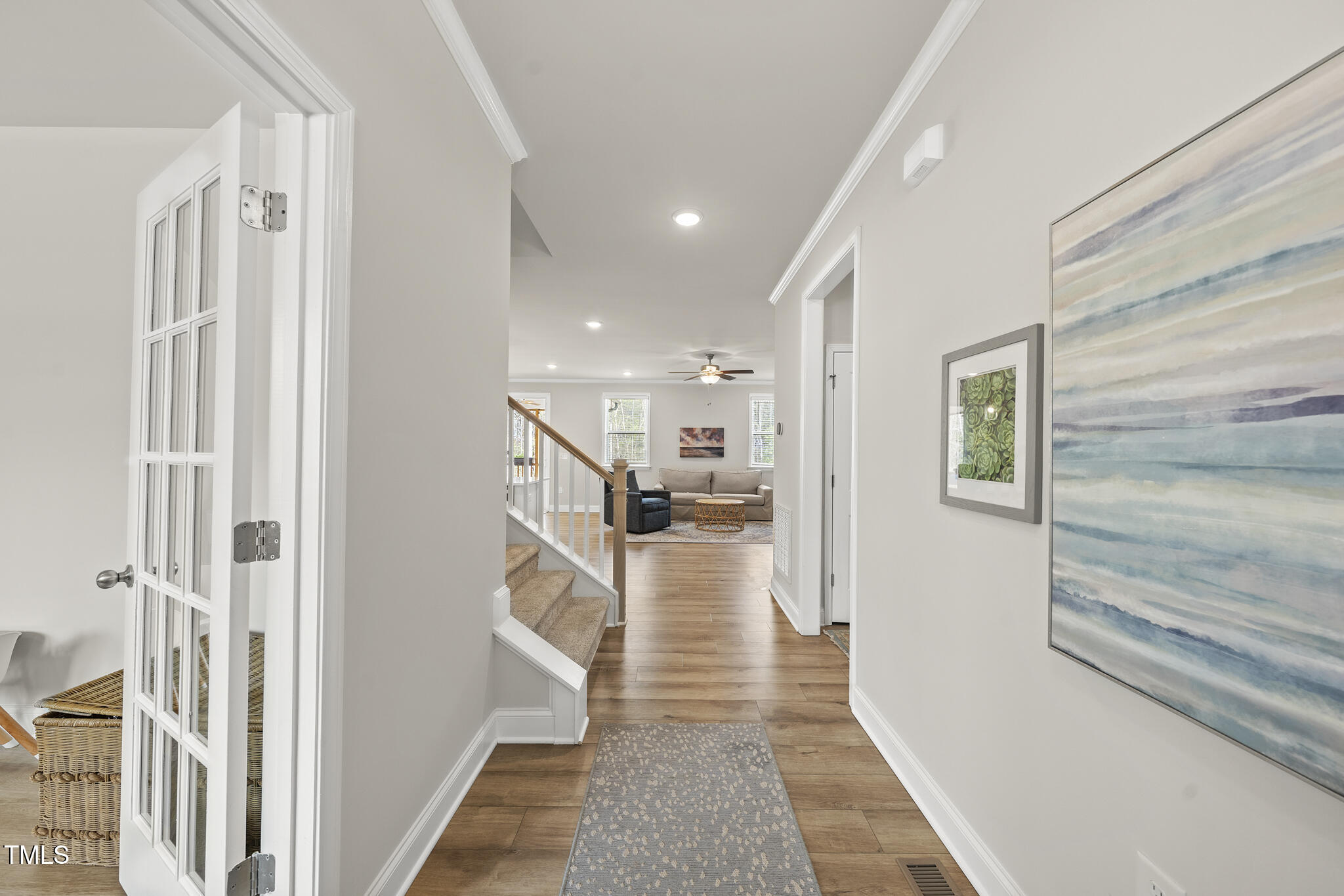 111 Kim Bark Path Garner, NC 27529 - Photo 6 of 52 a view of a hallway with wooden floor and staircase