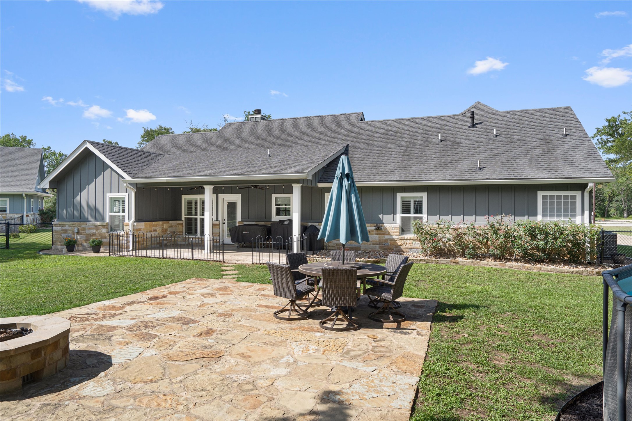 136 Fawn Hollow Elgin, TX 78621 - Photo 33 of 40 Expansive backyard featuring a natural stone patio and a built-in stone fire pit
