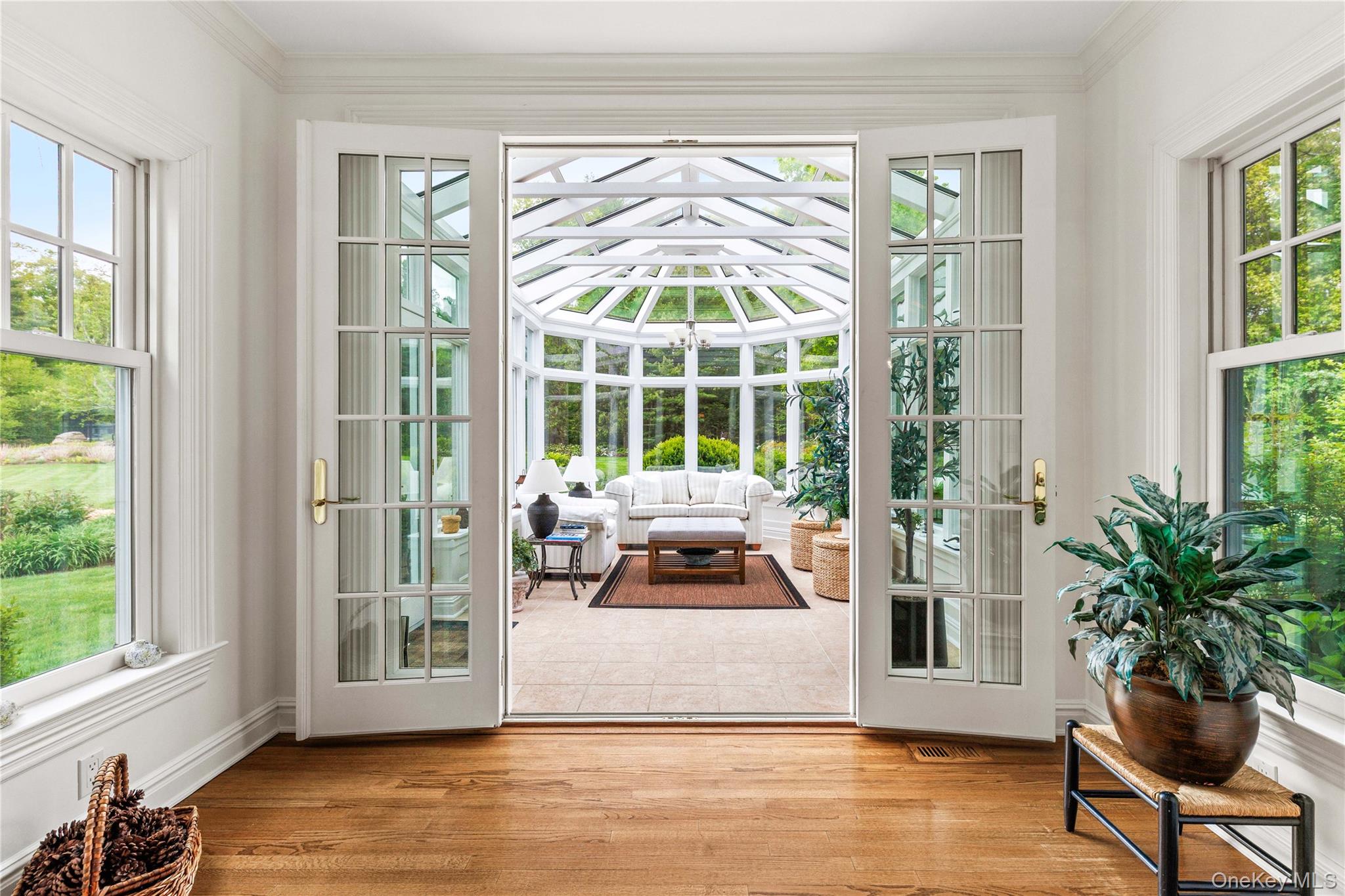 63 Old Mill River Road Pound Ridge, NY 10576 - Photo 11 of 47 a view of a living room and floor to ceiling window and wooden floor