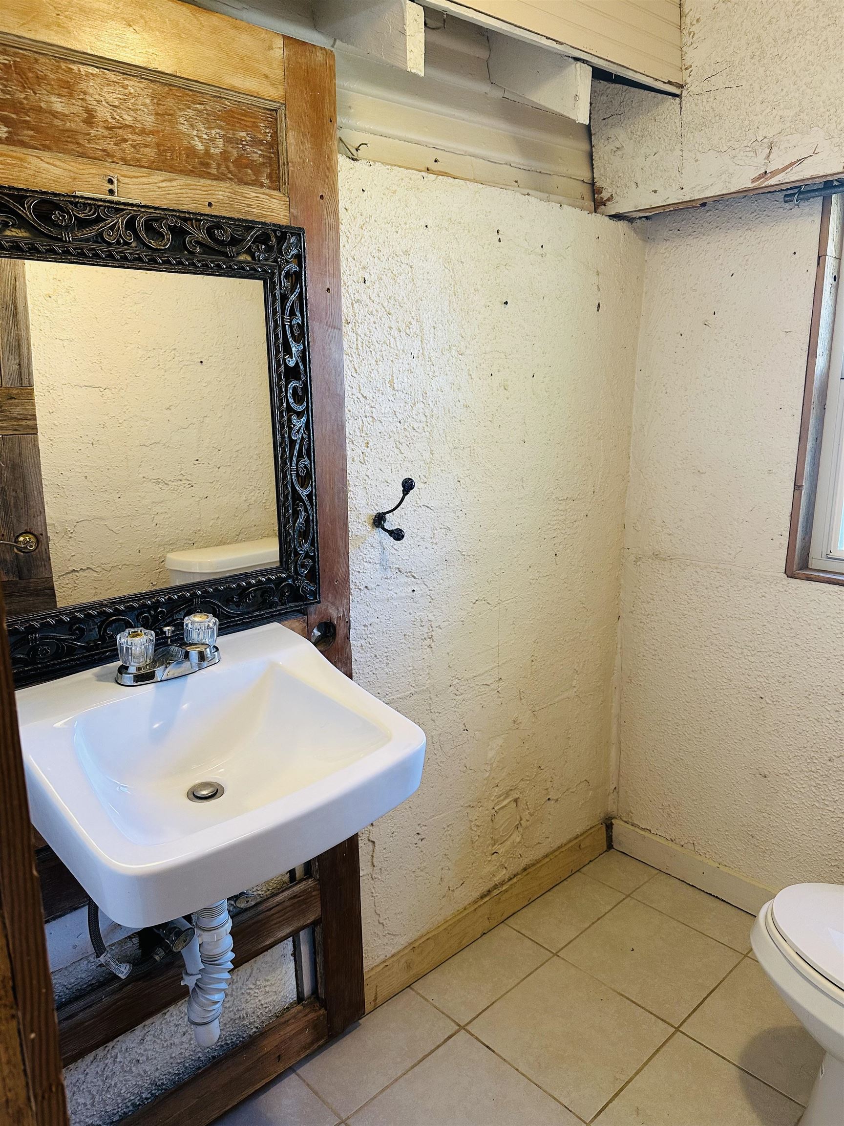 505 4th Street Lometa, TX 76853 - Photo 14 of 27 a bathroom with a sink a toilet and a mirror