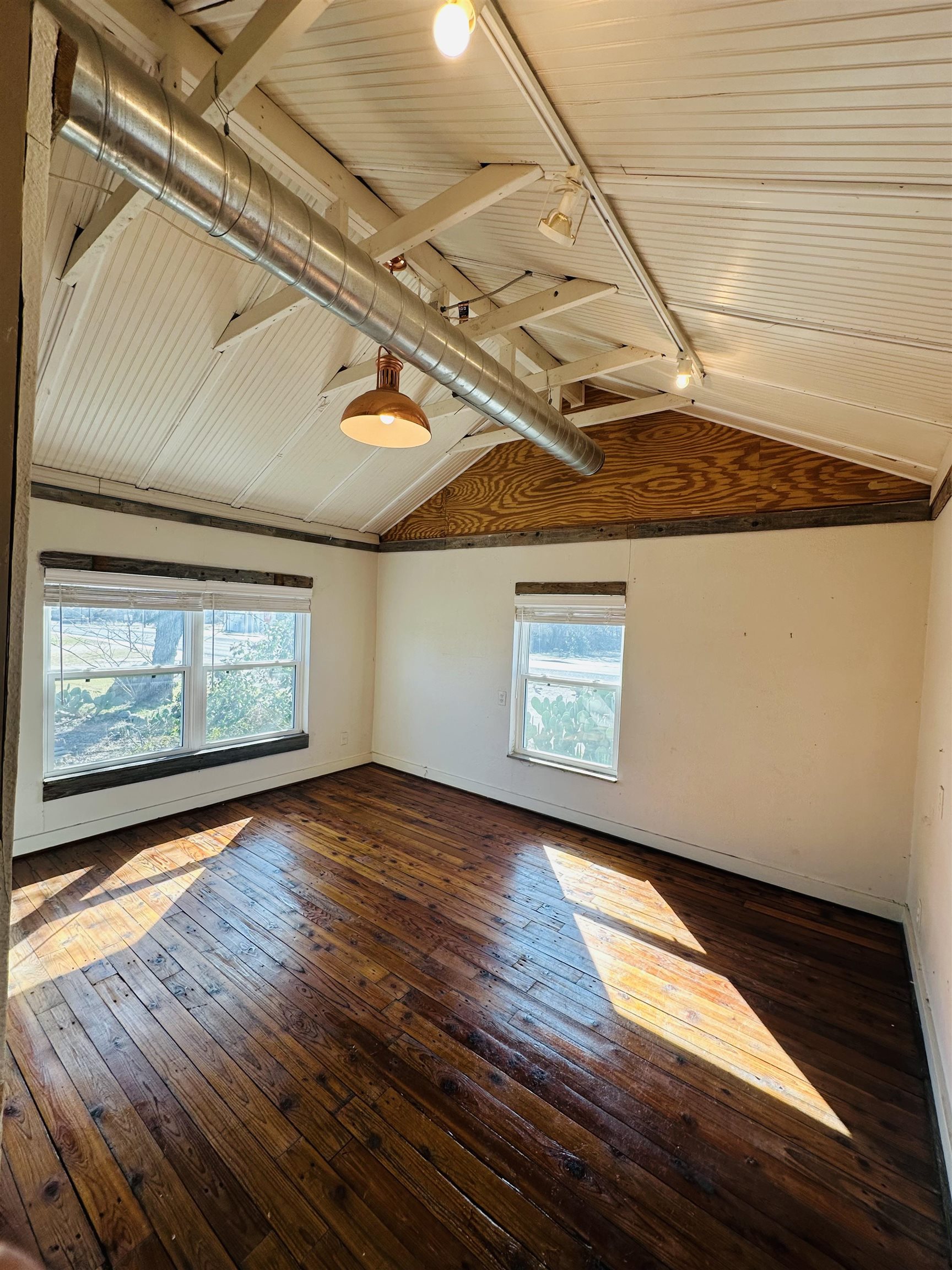 505 4th Street Lometa, TX 76853 - Photo 7 of 27 a view of an empty room with wooden floor and a window