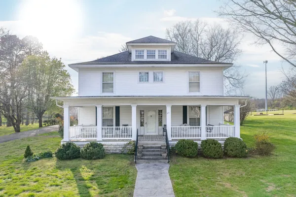 a front view of a house with garden