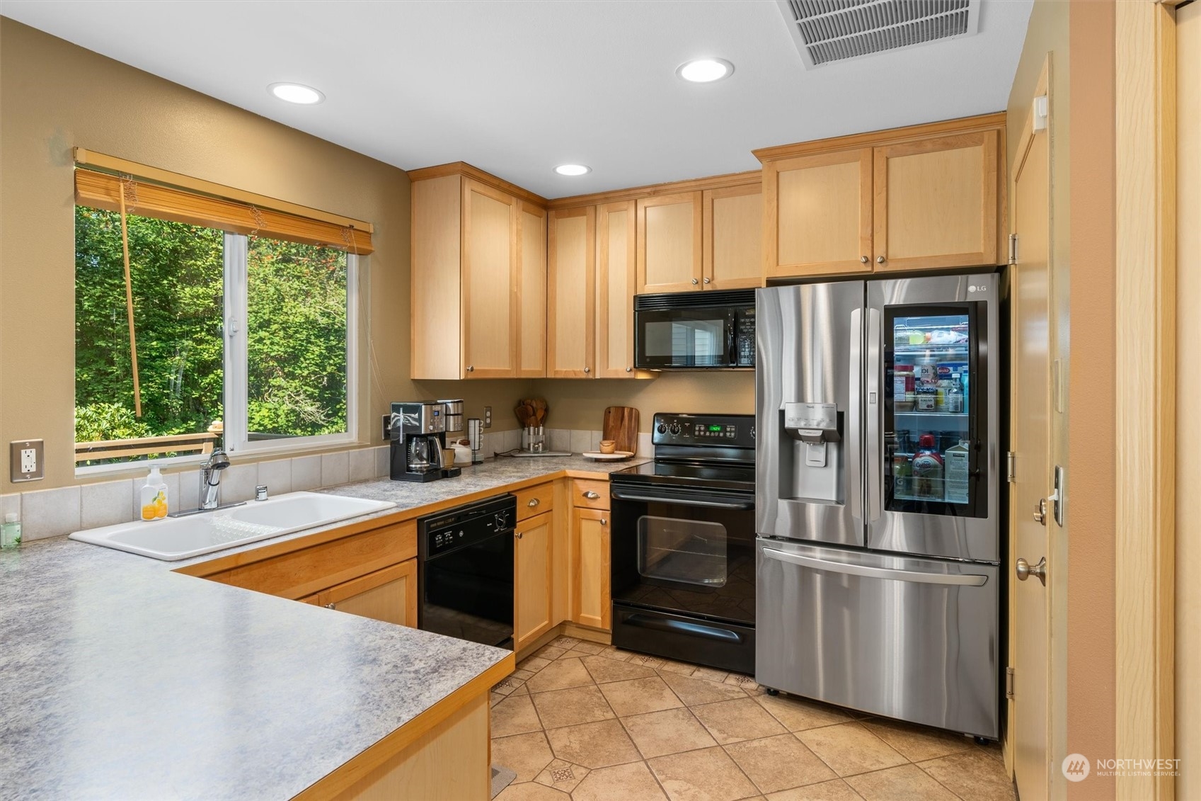 2505 194th Street Southeast Bothell, WA 98012 - Photo 11 of 31 a kitchen with stainless steel appliances a refrigerator sink and cabinets