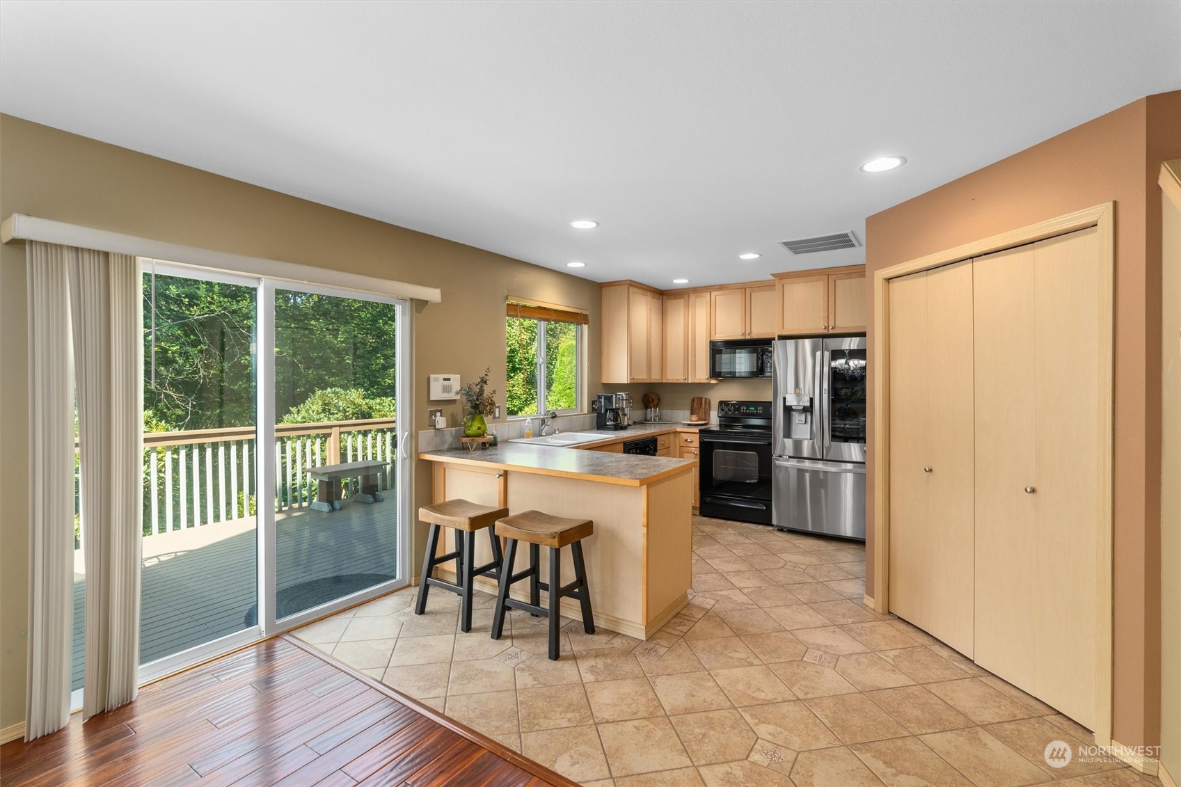 2505 194th Street Southeast Bothell, WA 98012 - Photo 10 of 31 a kitchen with a refrigerator a microwave oven dining table and chairs