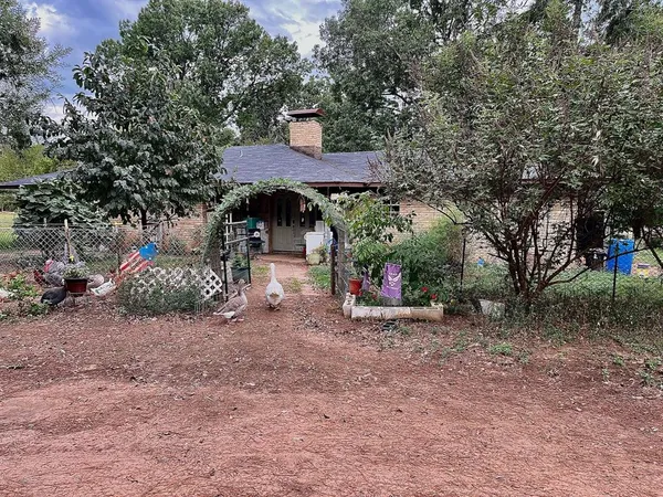 a view of a table and chairs under an umbrella
