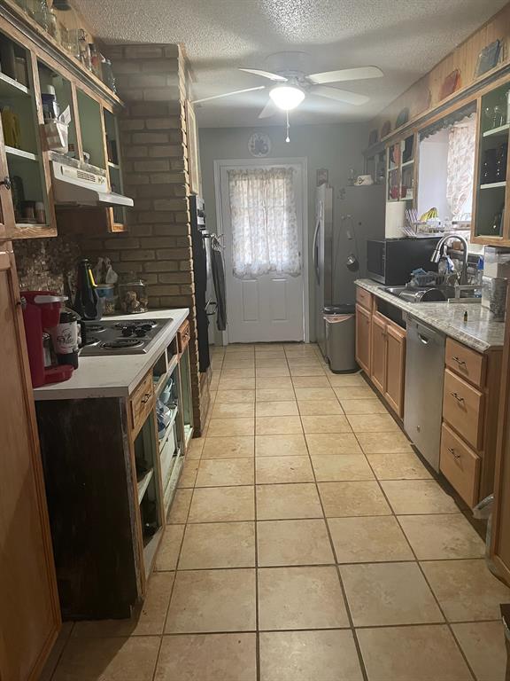 3640 Van Zandt County Road Ben Wheeler, TX 75754 - Photo 20 of 34 a kitchen with stainless steel appliances granite countertop a stove a sink and a refrigerator