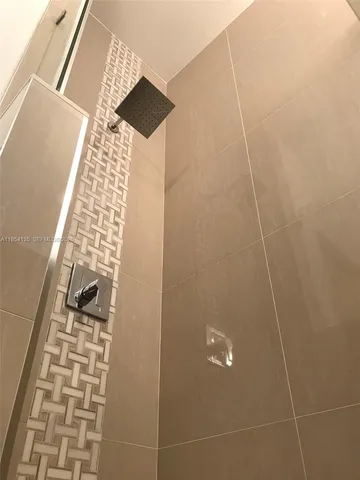 a bathroom with a sink a mirror and a bathtub