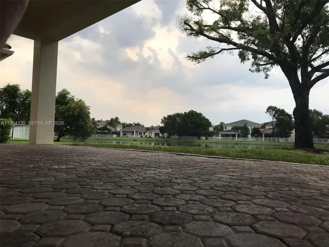 a view of a kitchen with granite countertop cabinets and stainless steel appliances