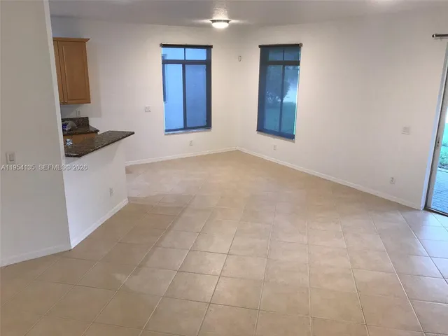 a view of an empty room and wooden floor