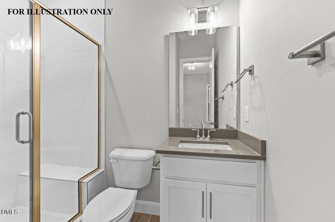 1032 Smoke Willow Way, Unit 148 Rolesville, NC 27571 - Photo 14 of 20 a bathroom with a granite countertop toilet sink and mirror