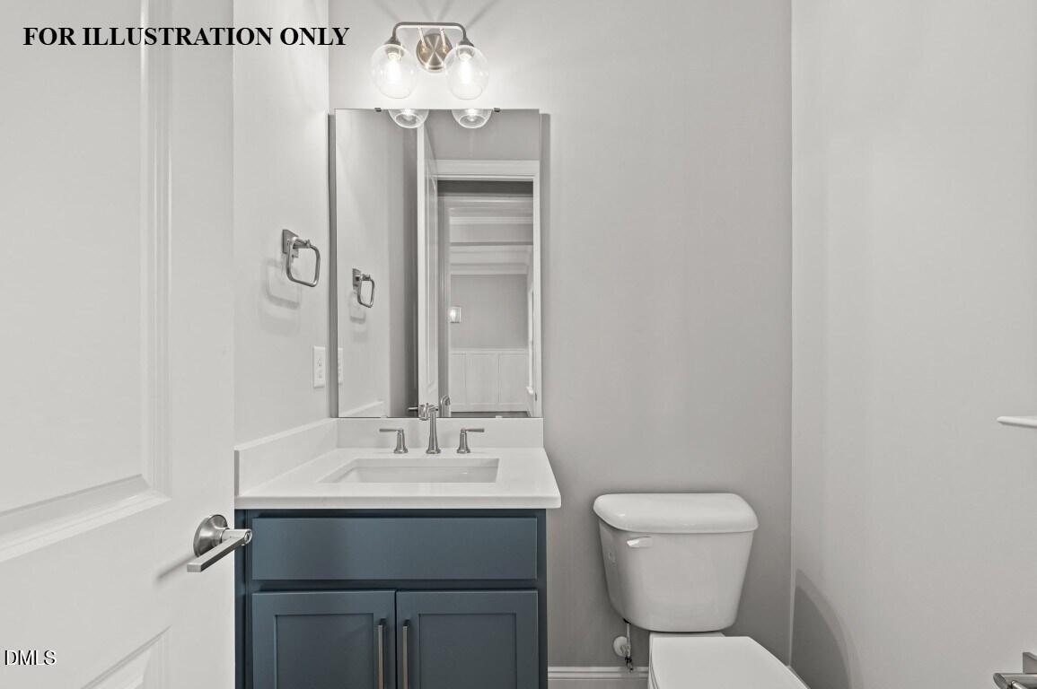 1032 Smoke Willow Way, Unit 148 Rolesville, NC 27571 - Photo 18 of 20 a bathroom with a toilet sink and mirror