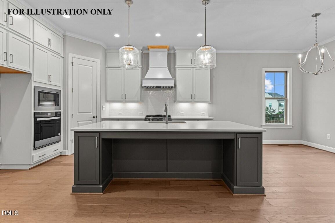 1032 Smoke Willow Way, Unit 148 Rolesville, NC 27571 - Photo 4 of 20 a large kitchen with granite countertop a sink cabinets and stainless steel appliances