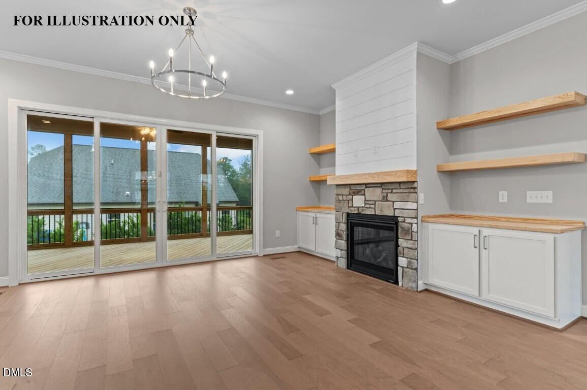 1032 Smoke Willow Way, Unit 148 Rolesville, NC 27571 - Photo 6 of 20 a view of a kitchen with a stove cabinets and a floor to ceiling window