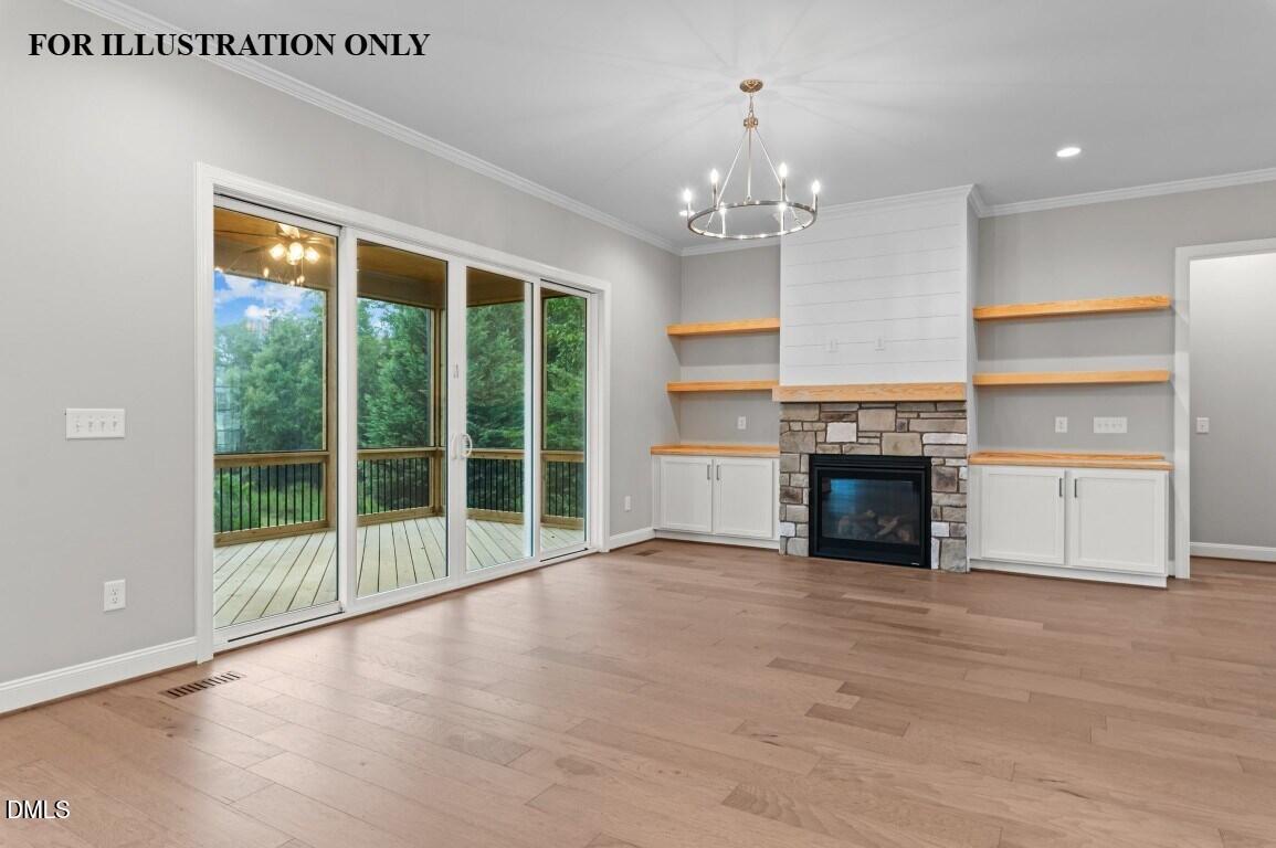 1032 Smoke Willow Way, Unit 148 Rolesville, NC 27571 - Photo 7 of 20 a view of an empty room with a fireplace and a window