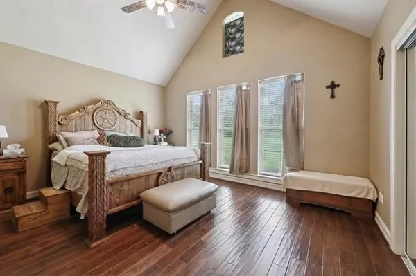 a bedroom with a bed and a chandelier