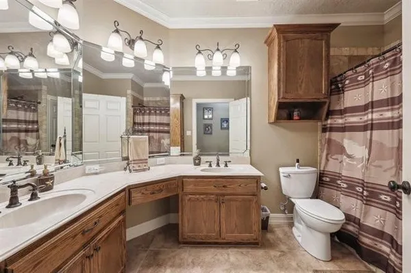 a bathroom with a sink a toilet a mirror and shower