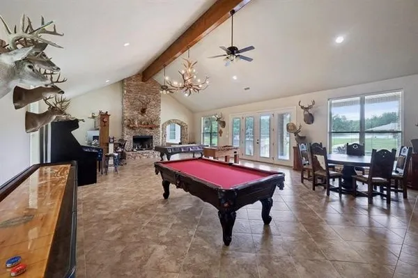 a living room with furniture a dining table and a chandelier
