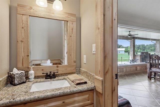 2014 Fish Lake Road Kountze, TX 77625 - Photo 26 of 35 a bathroom with a granite countertop sink and a mirror