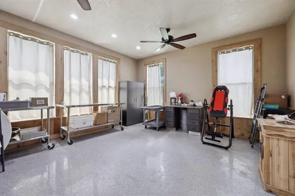 a view of game room with windows and air conditioner duct