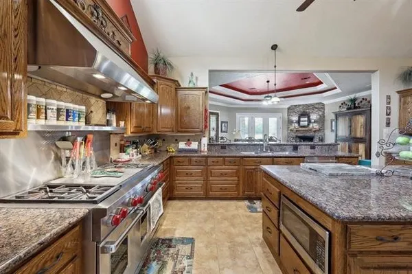a kitchen with stainless steel appliances granite countertop a stove and a sink