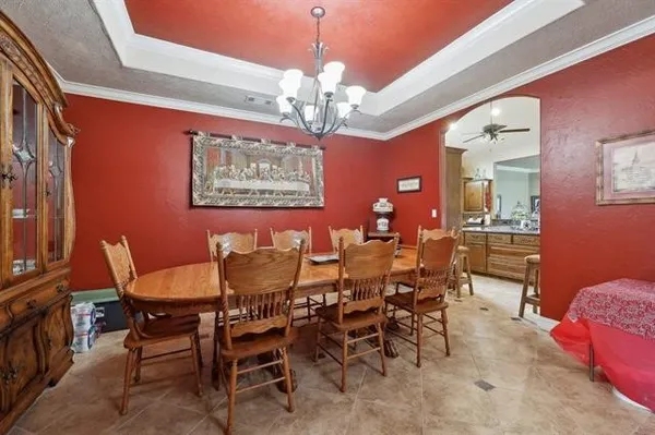 a view of a dining room with furniture and chandelier