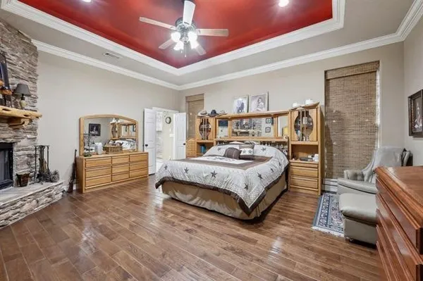 a bedroom with a bed a couch and dresser